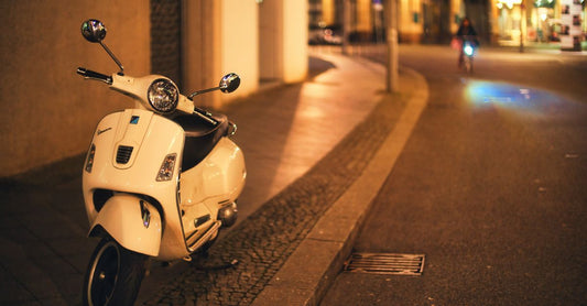 Vespa GTS auf nasser Straße mit sichtbarem Hinterrad und moderner Sicherheitstechnik